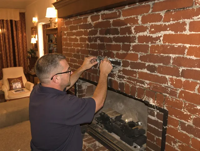 North Royalton Chimney Sweep expert fixing a fireplace in North Royalton, OH